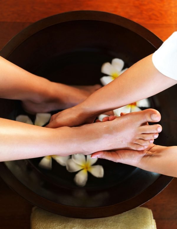 A pedicure foot bath with frangipani flowers