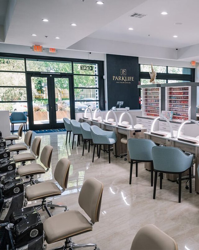 The Parklife salon floor — pedicure chairs, manicure stations and the polish wall
